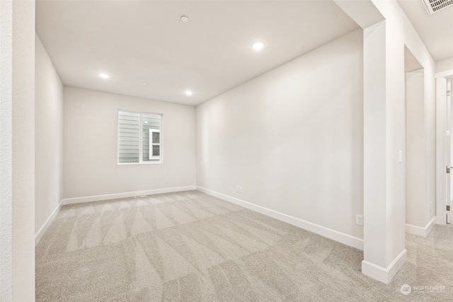 unfurnished room with light colored carpet