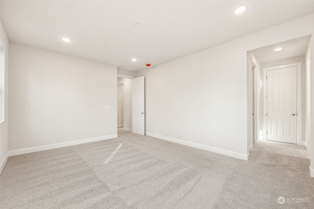 spare room with light colored carpet