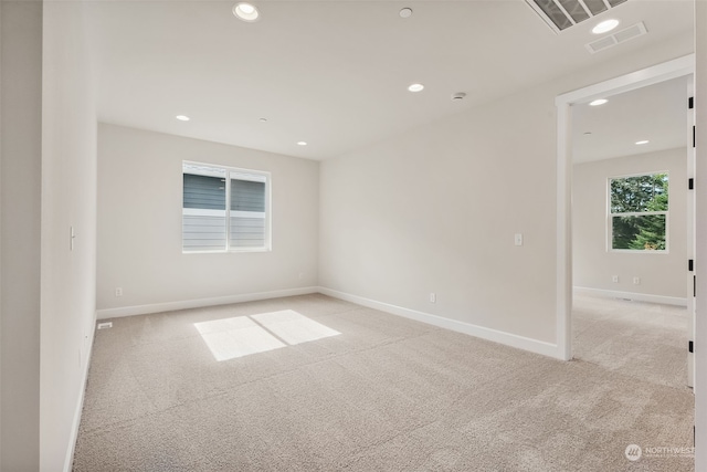 spare room featuring light colored carpet