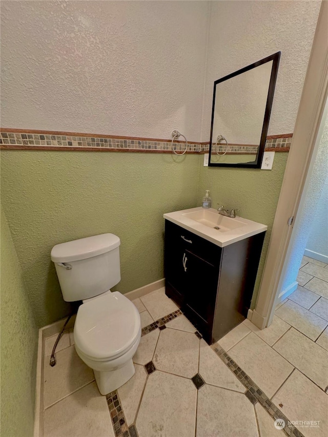 bathroom with tile patterned floors, vanity, and toilet