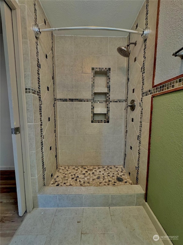 bathroom with tiled shower