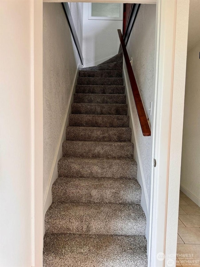 stairs featuring tile patterned floors