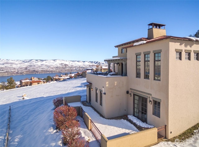 view of snow covered exterior featuring a mountain view