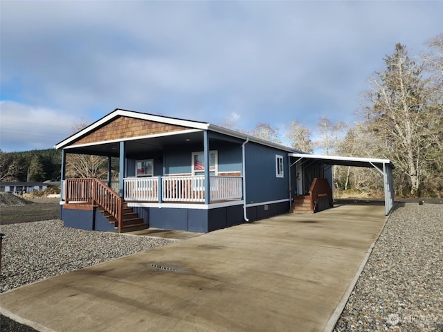 manufactured / mobile home with a carport and covered porch