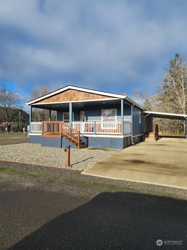 view of front of house with a carport and covered porch