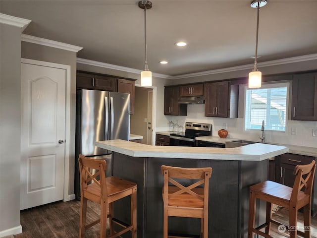 kitchen with a breakfast bar, dark brown cabinets, stainless steel appliances, and dark hardwood / wood-style floors