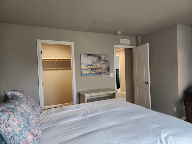 bedroom featuring a spacious closet and a closet