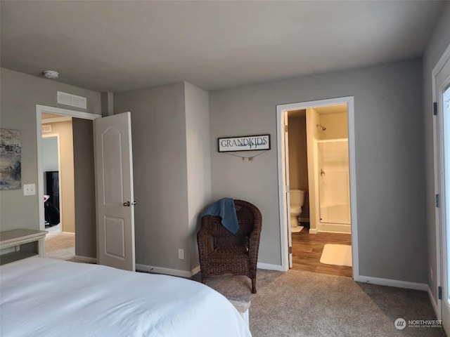 bedroom with light colored carpet and connected bathroom