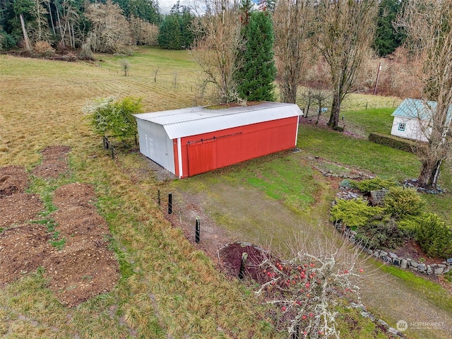 view of yard with a rural view and an outdoor structure