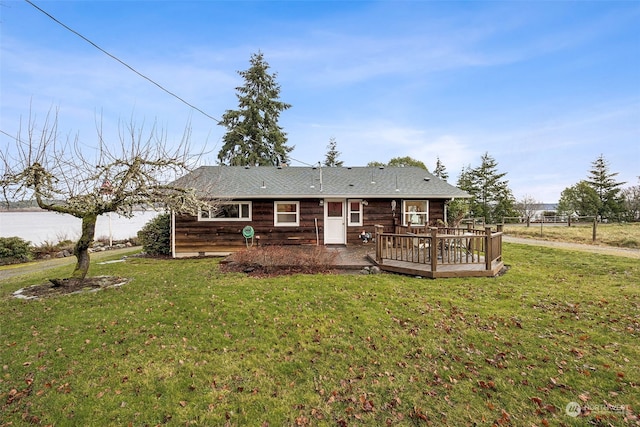 back of house with a yard and a deck