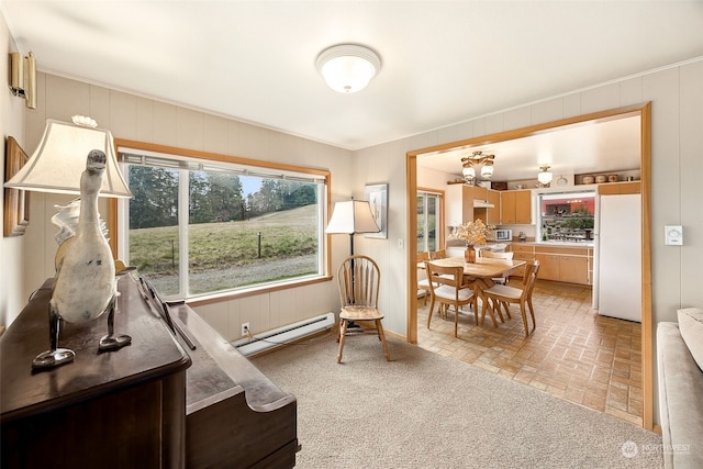 living area featuring a baseboard radiator and an inviting chandelier