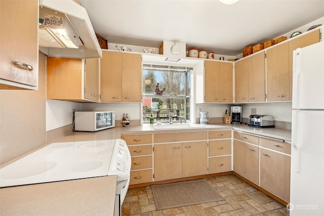 kitchen with light brown cabinetry, sink, white appliances, and custom exhaust hood