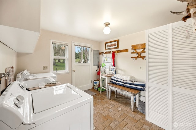 clothes washing area featuring washing machine and dryer and electric panel