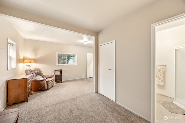 sitting room featuring light colored carpet