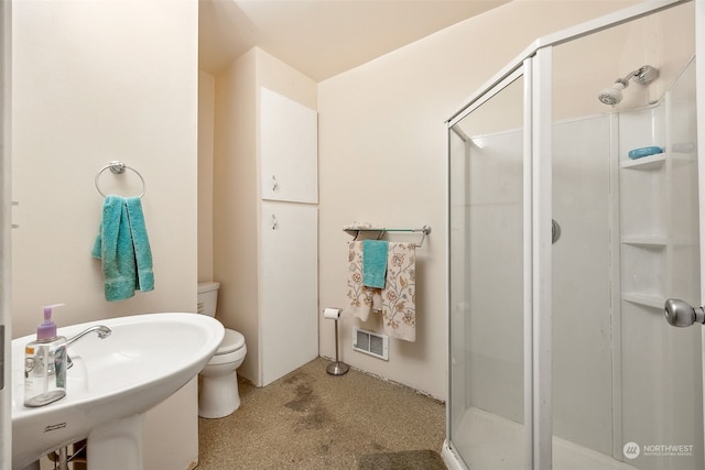 bathroom with toilet, an enclosed shower, and sink