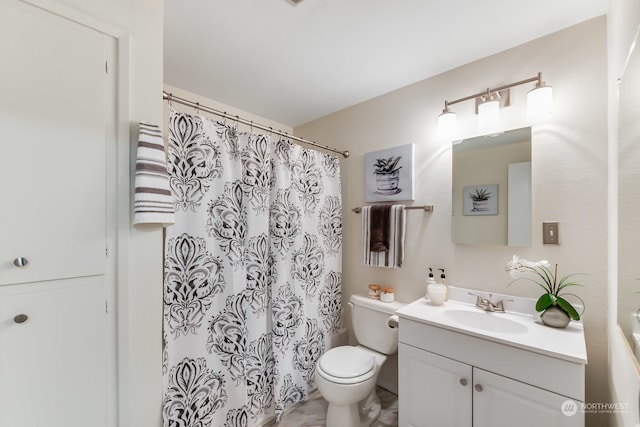 bathroom featuring vanity, toilet, and curtained shower