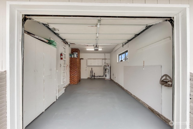 garage featuring electric water heater and a garage door opener