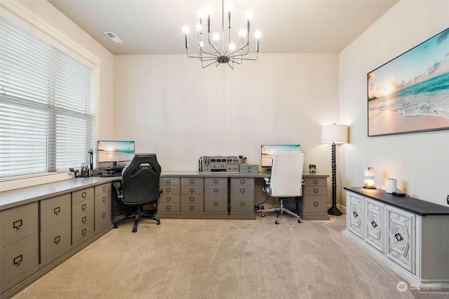 office area featuring an inviting chandelier, light carpet, and plenty of natural light