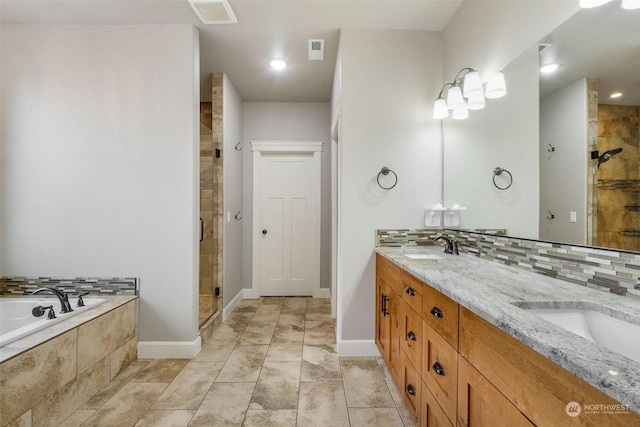 bathroom featuring independent shower and bath and vanity