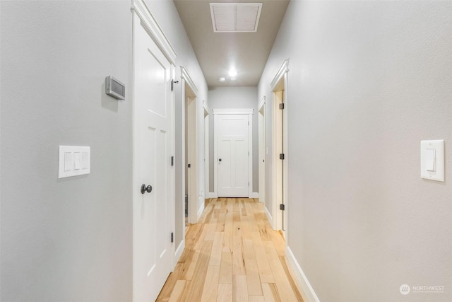 hall with light hardwood / wood-style floors