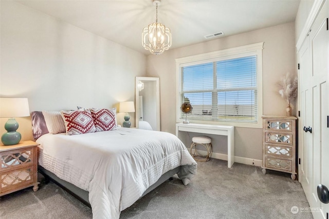 carpeted bedroom featuring a notable chandelier