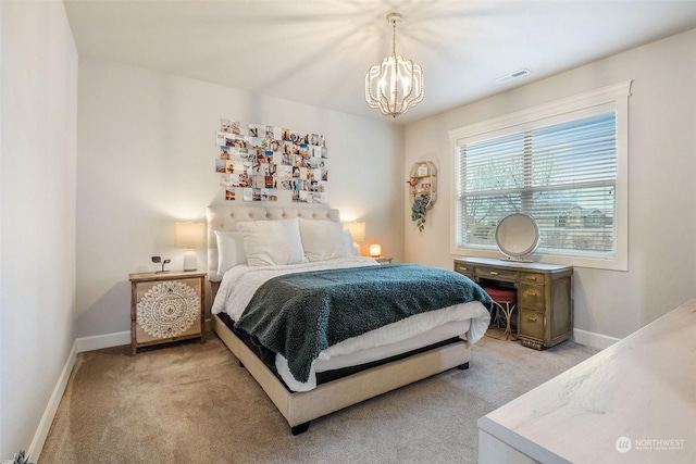 carpeted bedroom featuring a notable chandelier