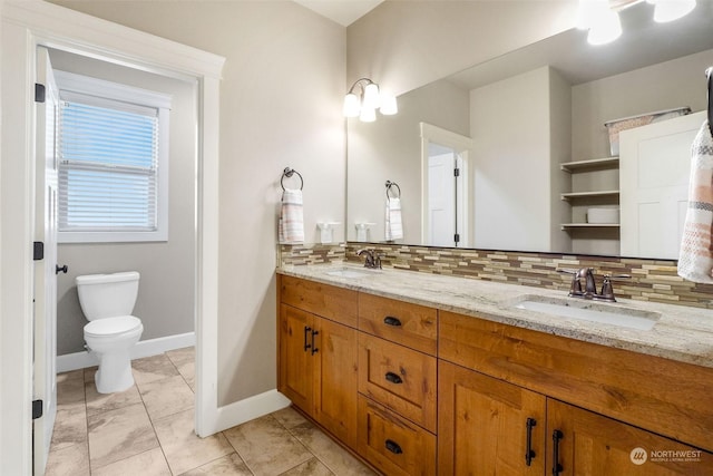 bathroom with toilet, tile patterned floors, vanity, and decorative backsplash