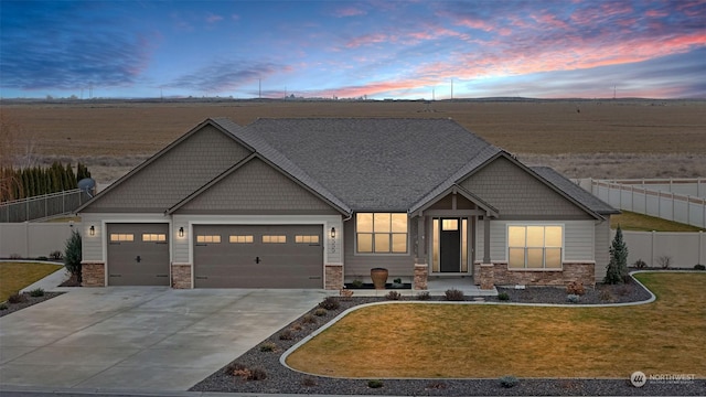 craftsman-style house with a garage and a lawn