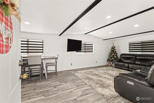 living room featuring light hardwood / wood-style flooring and lofted ceiling