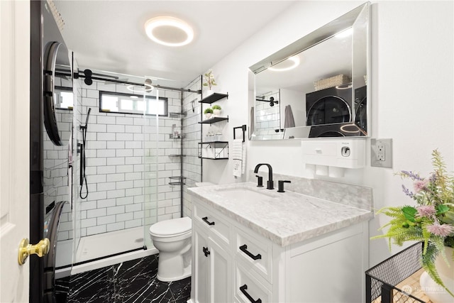 bathroom featuring vanity, toilet, and a shower with shower door