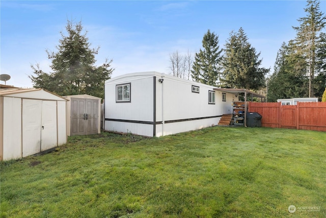 exterior space featuring a yard and a storage unit