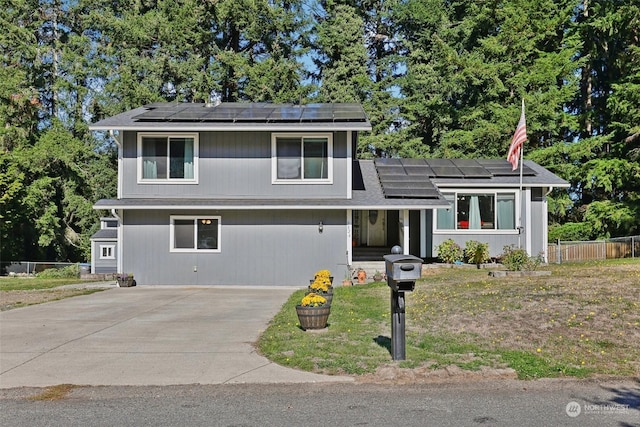 split level home featuring solar panels