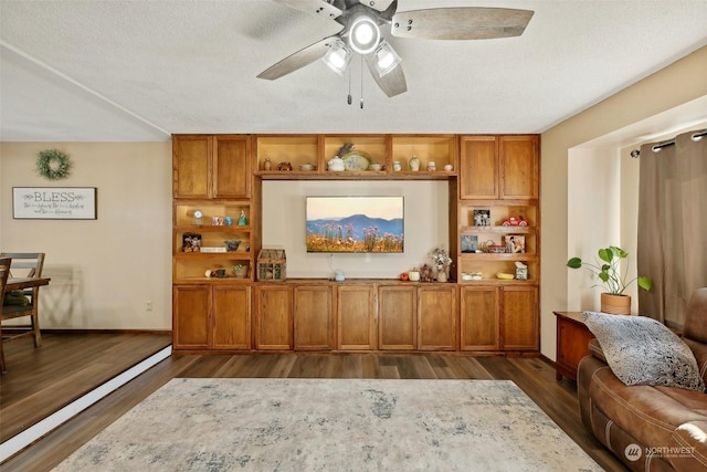 bar with ceiling fan, dark hardwood / wood-style flooring, and a textured ceiling