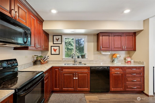 kitchen featuring sink, dark hardwood / wood-style floors, and black appliances