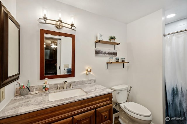 bathroom with a shower with shower curtain, vanity, toilet, and ceiling fan