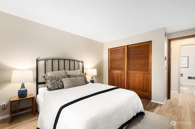 bedroom featuring a closet and light wood-type flooring