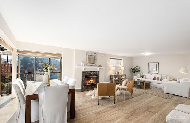 dining area with a premium fireplace and light wood-type flooring