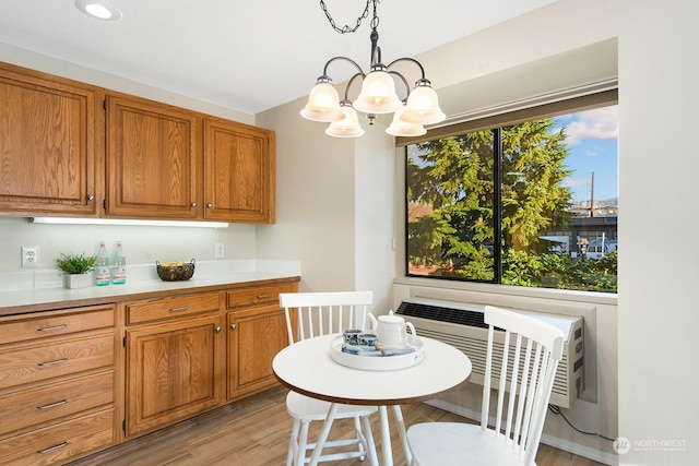 kitchen featuring hanging light fixtures, a notable chandelier, and light hardwood / wood-style flooring