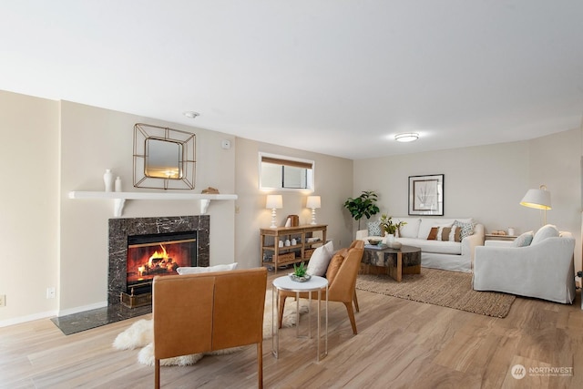 living room featuring a fireplace and light wood-type flooring