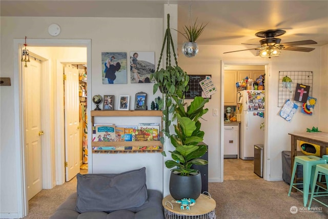 interior space with ceiling fan and light carpet