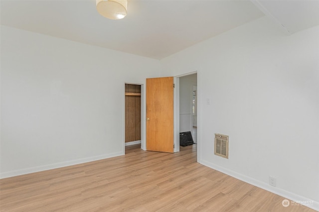 spare room featuring light wood-type flooring