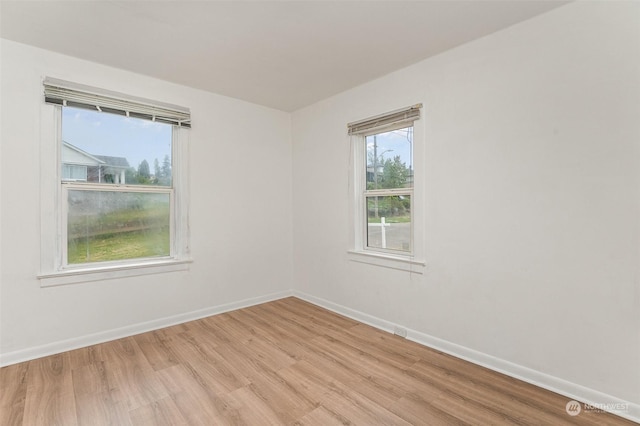 empty room with light hardwood / wood-style flooring