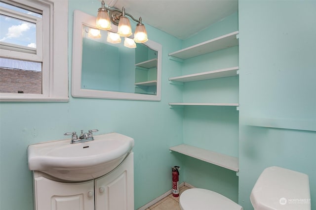 bathroom featuring tile patterned floors, vanity, and toilet