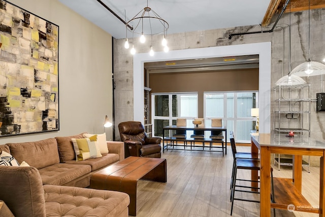 living room featuring a chandelier and wood-type flooring