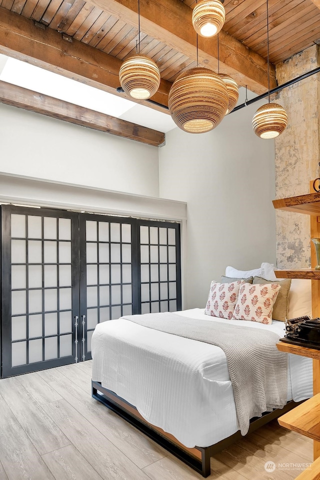 bedroom with beam ceiling, hardwood / wood-style flooring, and wood ceiling