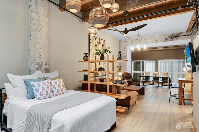 bedroom with hardwood / wood-style flooring, a notable chandelier, wooden ceiling, and beamed ceiling