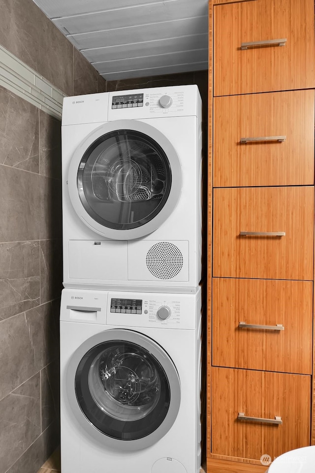 laundry area featuring stacked washer and clothes dryer