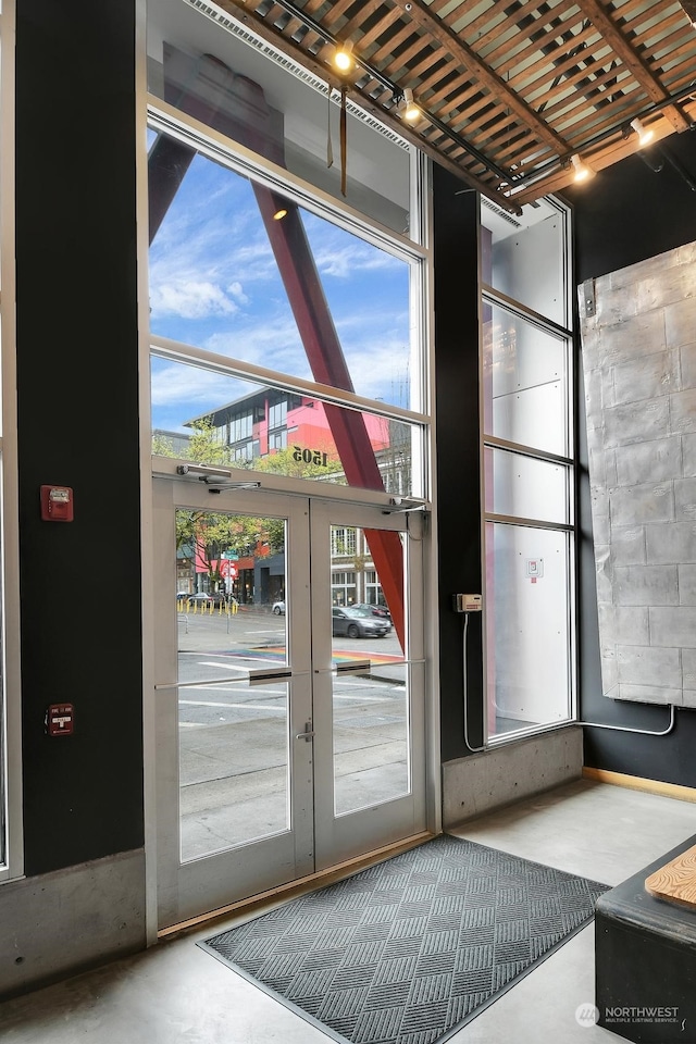 entryway featuring french doors and concrete floors