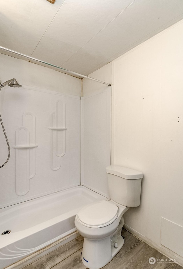 bathroom featuring hardwood / wood-style floors, toilet, and walk in shower