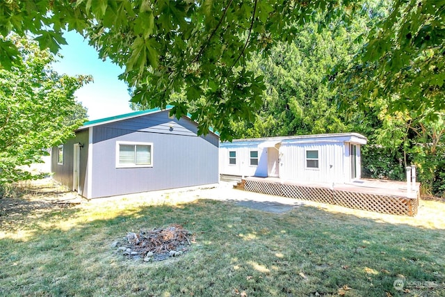 view of front of house featuring a front yard and a deck